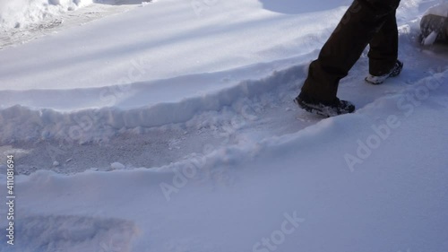 The man is removing snow after a blizzard