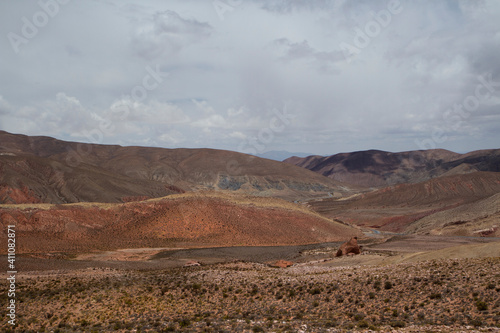 The arid desert.  View of the dry land, valley and colorful mountains under a beautiful sky, high in the Andes mountain range.