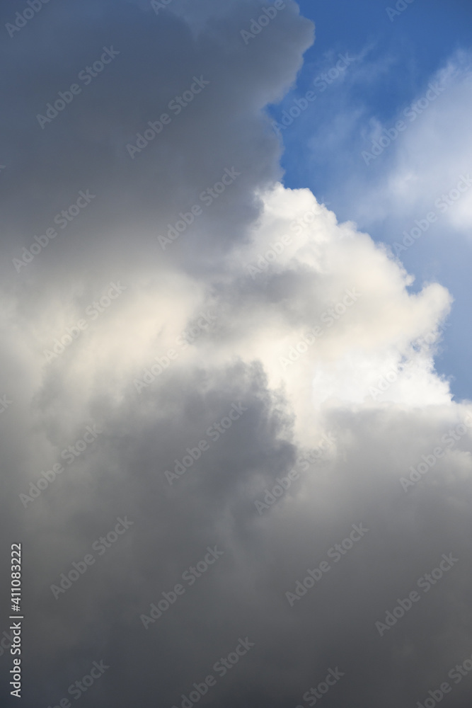 Dramatic and glowing cloudscape of blue sky and white and gray clouds as a nature background
