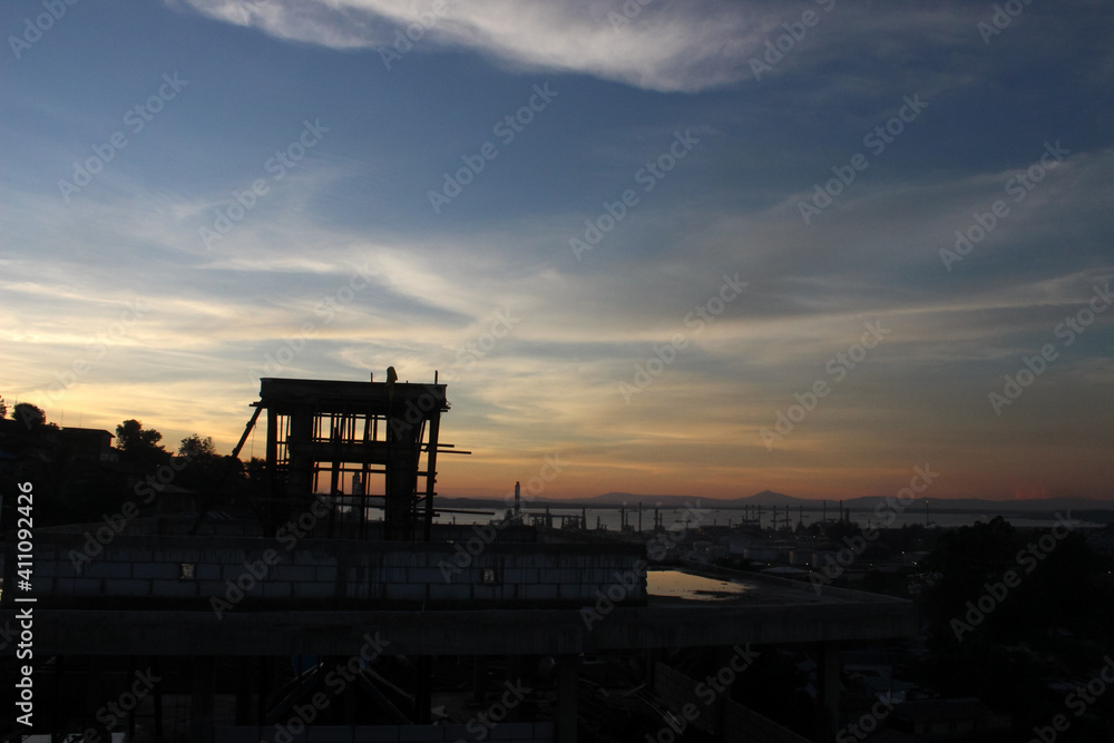 Silhouette of an under-construction building in the sunset