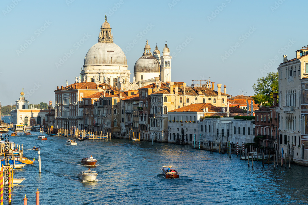 Beautiful Venetian cityscape at sunset, with a view on the Grand Canal and the domes of Santa Maria della Salute, Venice, Italy