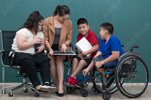 Portrait group of special kids classroom, disable and down syndrome boys, girl and teacher taking photo together with happiness and intimate pose