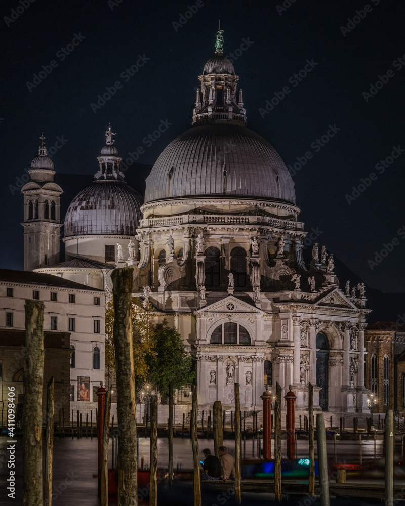 Night view of the church of Santa Maria della Salute with its prominent domes on the Gran Canal, Venice, Italy