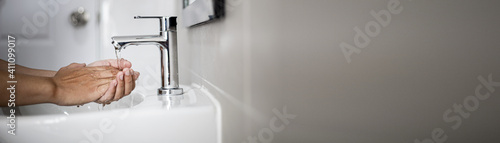 Photography People washing their hands in the sink, washing their hands thoroughly is a precautionary measure against COVID-19 infection