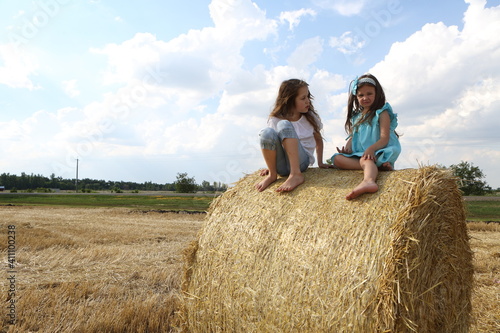 Two little girls playing in a wheat field