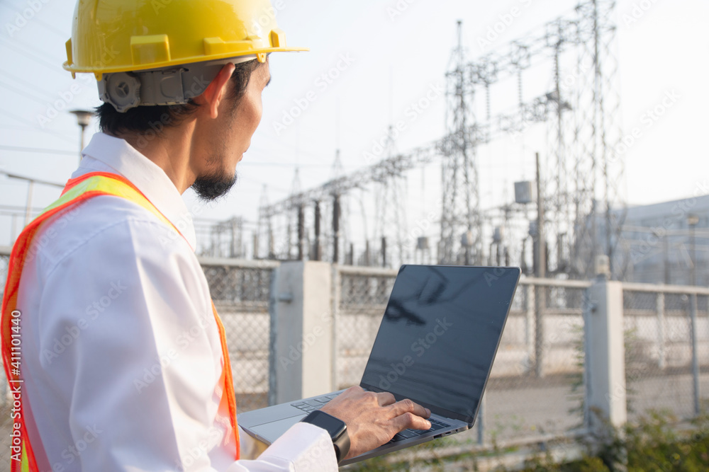 Engineer hold laptop computer inspection on site power plant high volte system Engineer hold laptop computer inspection on site power plant high volte system