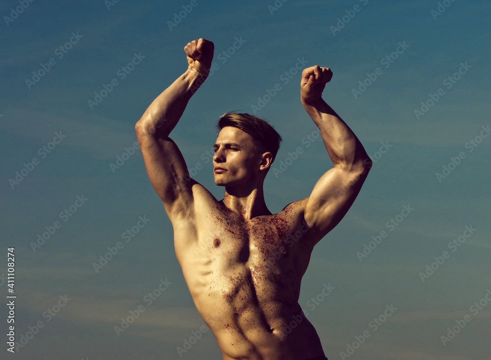 Man with glitter on bare chest. Athletic bodybuilder pose as hercules. Gladiator or atlant. Man with muscular wet body. - obrazy, fototapety, plakaty 