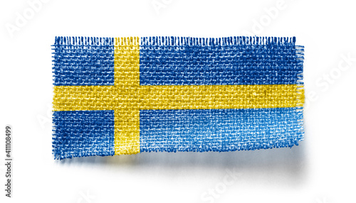 Sweden flag on a piece of cloth on a white background