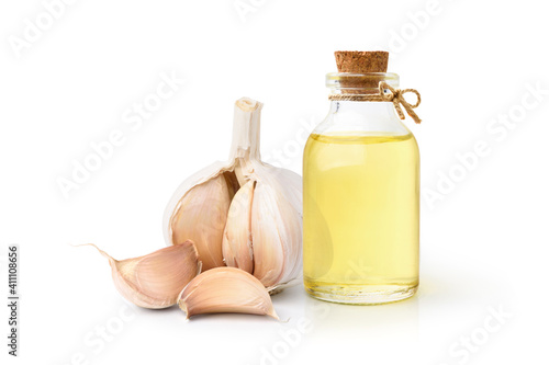 Garlic oil with Garlic Cloves and Bulb isolated on white background.