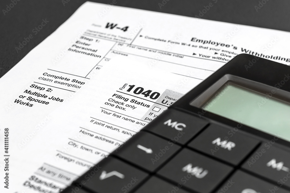 Calculator with tax forms on black background. Calculating tax and financial report. Calculator with tax forms on black background. Calculating tax and financial report.