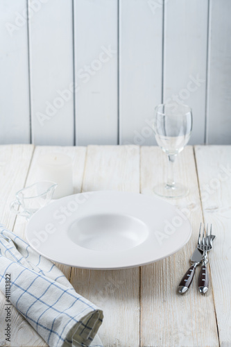 plate and glass on a white wooden background.