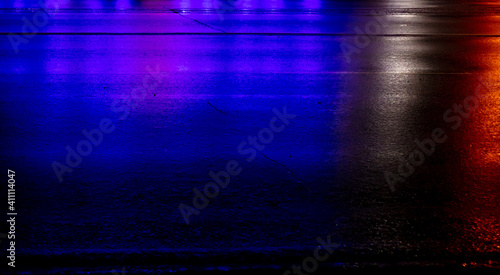 Blue and red lights on the asphalt at night