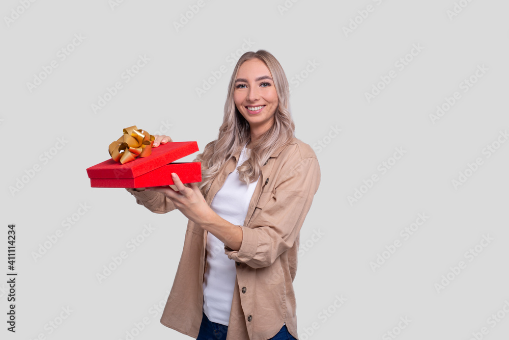 Girl Holding Present Watching to Camera. Girl Holding Gift. Girl Holding Present Watching to Camera. Girl Holding Gift.