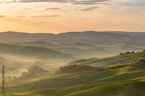 Dawn in a Rural rolling landscape with fog