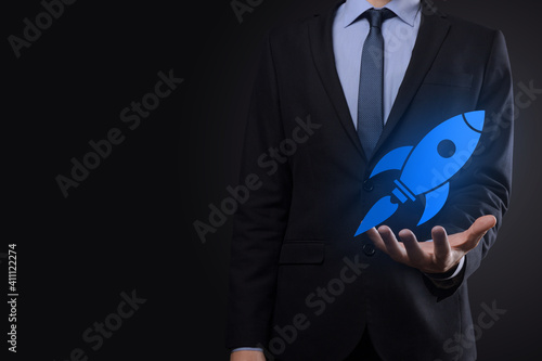 Start up concept with businessman holding abstract digital rocket icon rocket is launching and soar flying