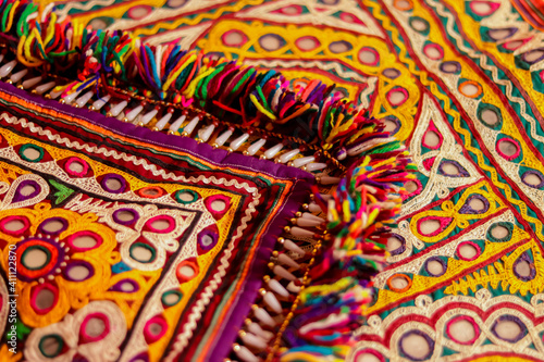 Beautiful view of colorful ethnic belts with mirrors and shells at market in Rajasthan, India,multicolour ethnic embroidery,Gujarat india embroidery craft close up view,pakistan embroidery