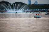 People ride duck boat at public park name Suan Luang Rama IX on sunset time Bangkok, Thailand.