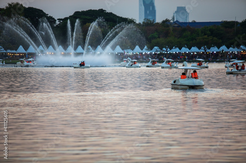 People ride duck boat at public park name Suan Luang Rama IX on sunset time Bangkok, Thailand.