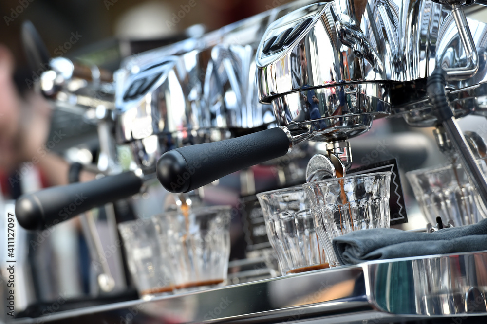 Espresso. Detail of coffee flowing from a professional espresso machine. Espresso. Detail of coffee flowing from a professional espresso machine.