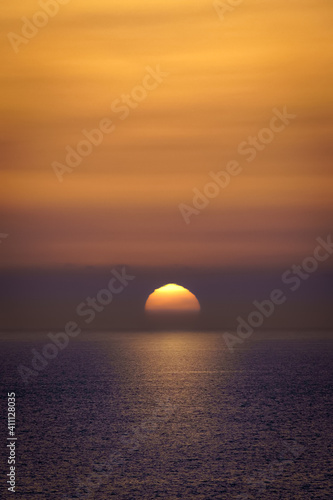 Fototapeta Naklejka Na Ścianę i Meble -  Sunset over the horizon of the sea, orange sunset colors, sea waves and a feeling of tranquility. Gran Canaria.