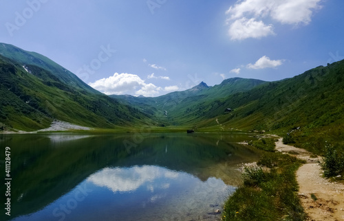 Fototapeta Naklejka Na Ścianę i Meble -  trail for hiker on the shore from a gorgeous mountain lake
