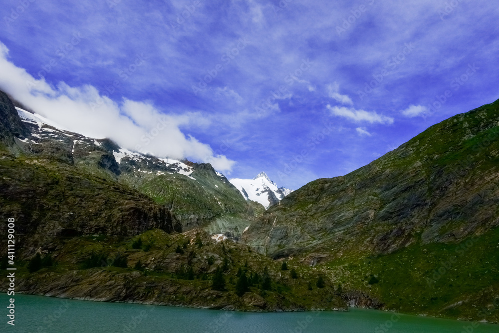 wonderful high mountains with blue sky and a water in the front wonderful high mountains with blue sky and a water in the front