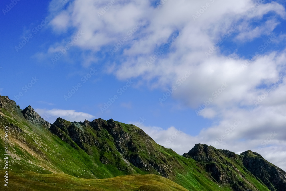 wonderful green rocky mountains and blue sky with clouds wonderful green rocky mountains and blue sky with clouds