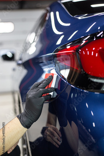 Car detailing - Hands with polisher in auto repair shop. Selective focus.. © Make_story Studio
