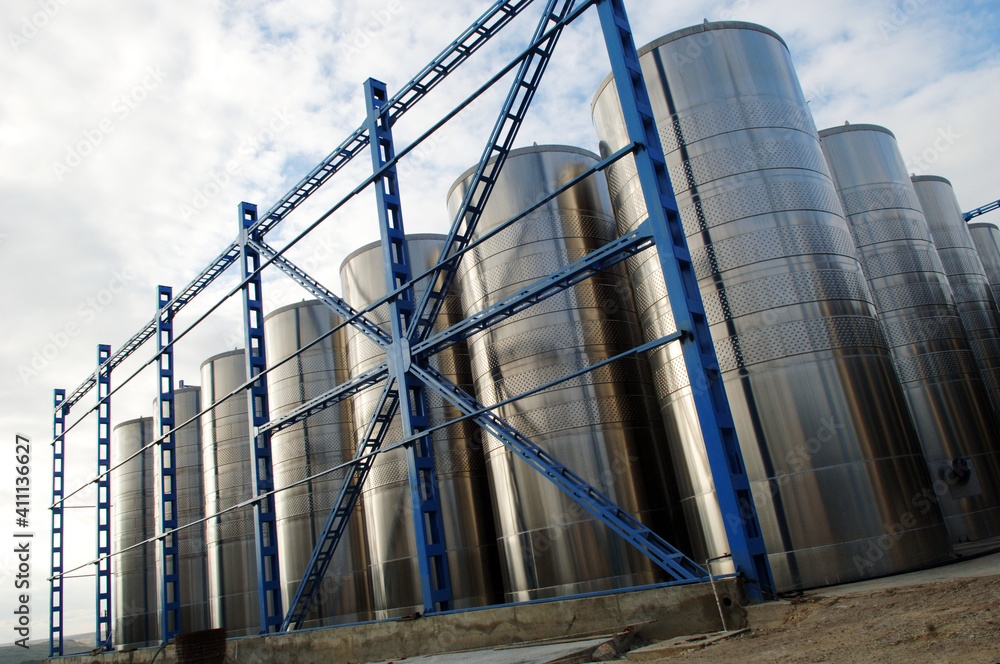 Fototapeta premium Winery. Stainless steel cylinders in a modern winery. day photo.