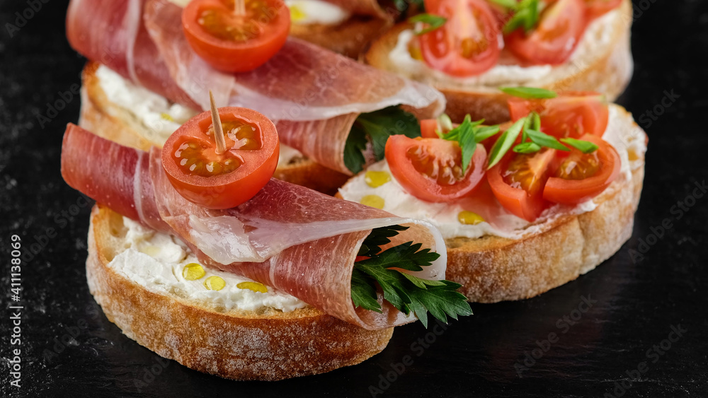 bruschetta with Italian prosciutto and tomatoes close up bruschetta with Italian prosciutto and tomatoes close up