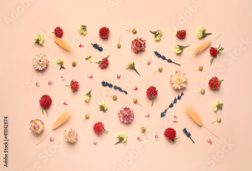 Flat lay composition with beautiful dried flowers on pink background