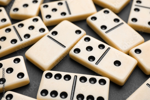 Classic domino tiles on black background  closeup