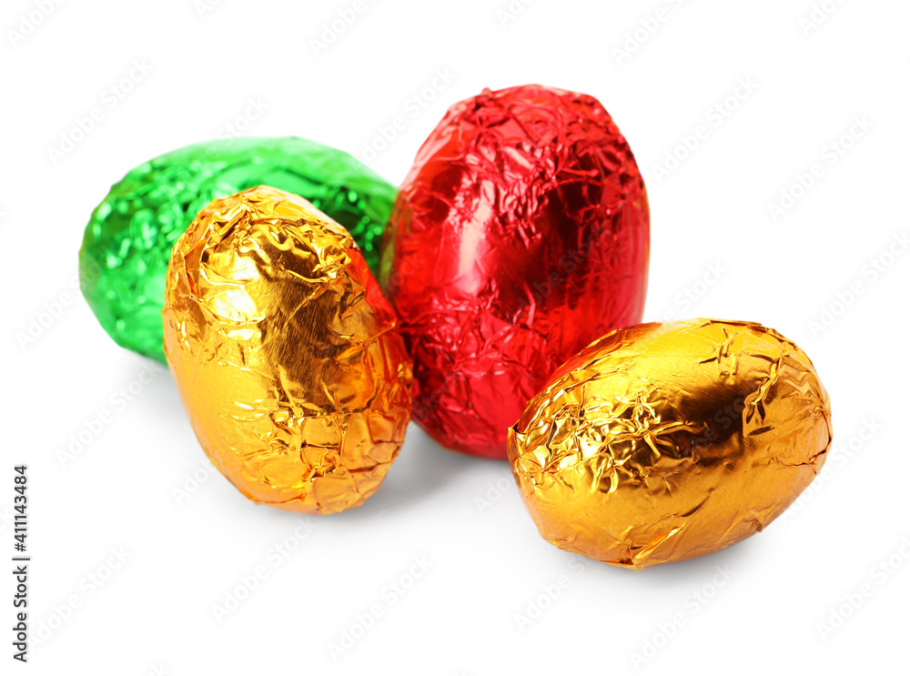 Chocolate eggs wrapped in bright foil on white background Chocolate eggs wrapped in bright foil on white background