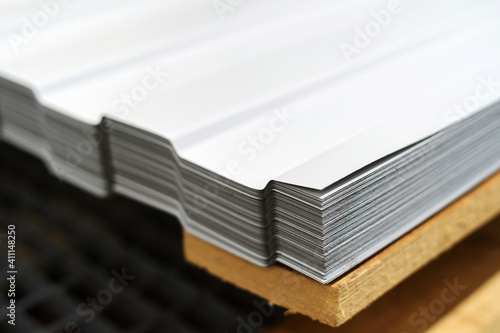 Metal corrugated board. A stack of roofing sheets is in the store's warehouse. Close-up. Copy space © Dmitry