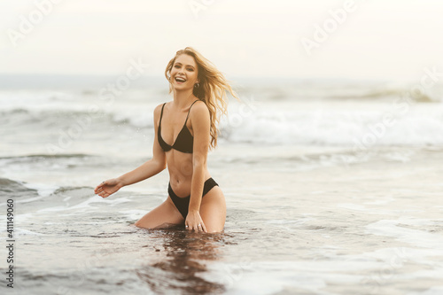 Young female enjoying sunny day on tropical beach Bali Indonesia
