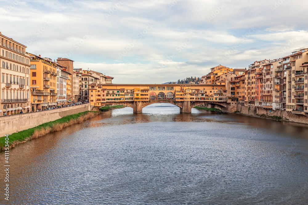 Arno river leading to the famous bridge Ponte Vecchio at the beautiful evening in Florence, Italy