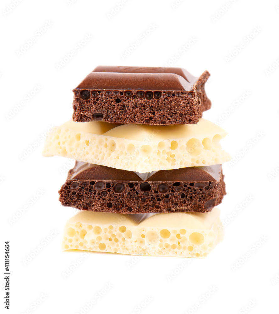 Porous chocolate pieces isolated on white background. Black and white aerated chocolate. Porous chocolate pieces isolated on white background. Black and white aerated chocolate.