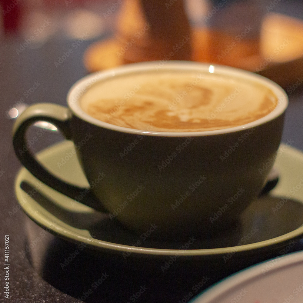 Soy flat white in cup on saucer