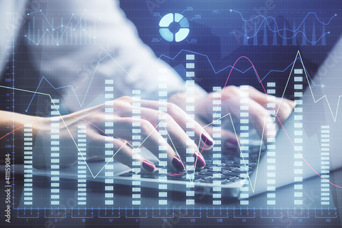 Double exposure of businesswoman hands typing on computer and forex chart hologram drawing. Financial analysis concept.