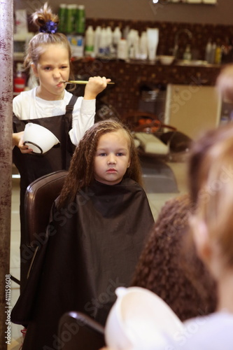 Two little girls playing barbershop