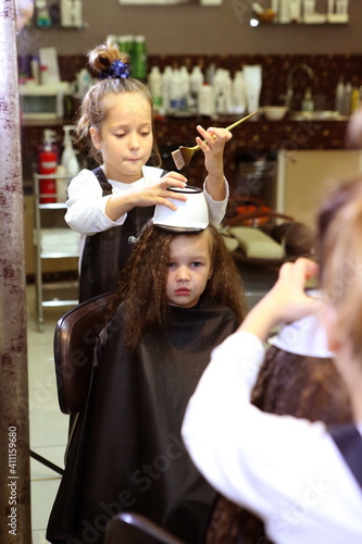 The girl dyes her hair. Barbershop