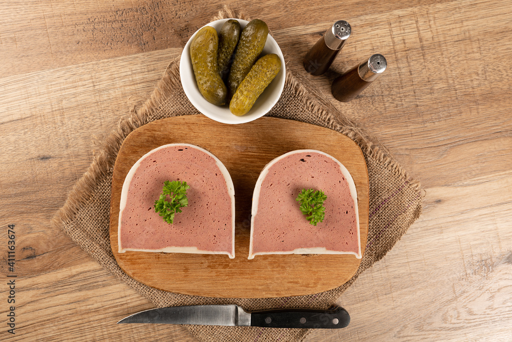 Liver pate cut on a bun with cucmber and parsley Liver pate cut on a bun with cucmber and parsley