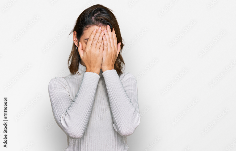 Young caucasian girl wearing casual clothes with sad expression covering face with hands while crying. depression concept. Young caucasian girl wearing casual clothes with sad expression covering face with hands while crying. depression concept.