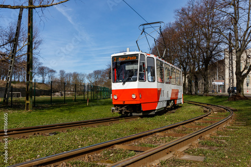 tram approaching on curved railway on a sunny day