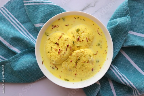 Rasmalai, Rossomalai, Roshmolai, Rasamalei is a very popular Indian dessert. It's a Similar dish to Rasgulla. It is a sweet delicacy made with Indian cottage cheese or chenna. Copy space. photo