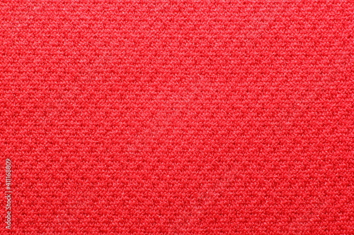 polyester cationic texture material red synthetic fabric macro elastic band background closeup