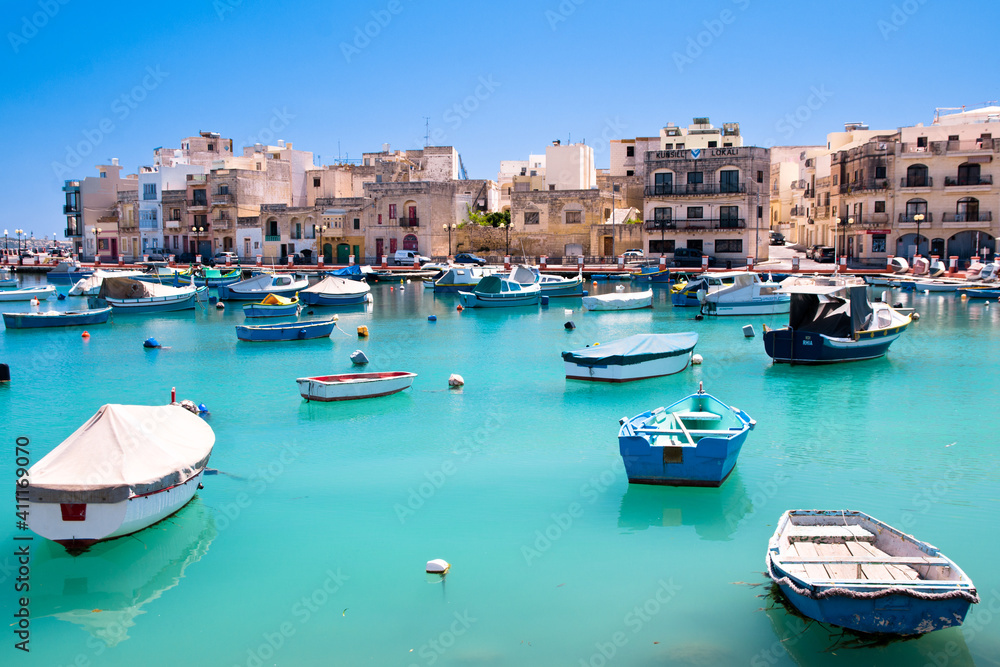 A lot of boats in a bay on sea in a Matese fishing village port, Malta