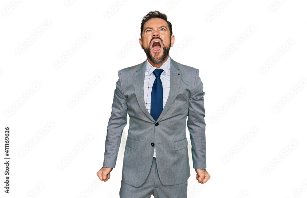 Middle age man wearing business clothes angry and mad screaming frustrated and furious, shouting with anger. rage and aggressive concept.