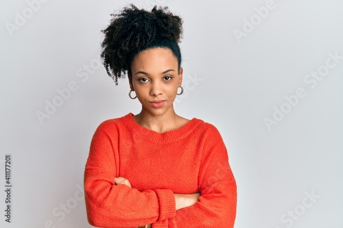 Young african american girl wearing casual clothes skeptic and nervous, disapproving expression on face with crossed arms. negative person. © Krakenimages.com