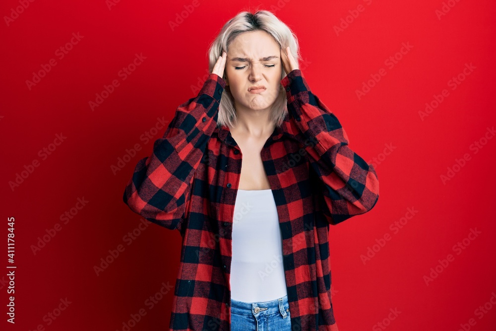 Young blonde girl wearing casual clothes with hand on head, headache because stress. suffering migraine. Young blonde girl wearing casual clothes with hand on head, headache because stress. suffering migraine.